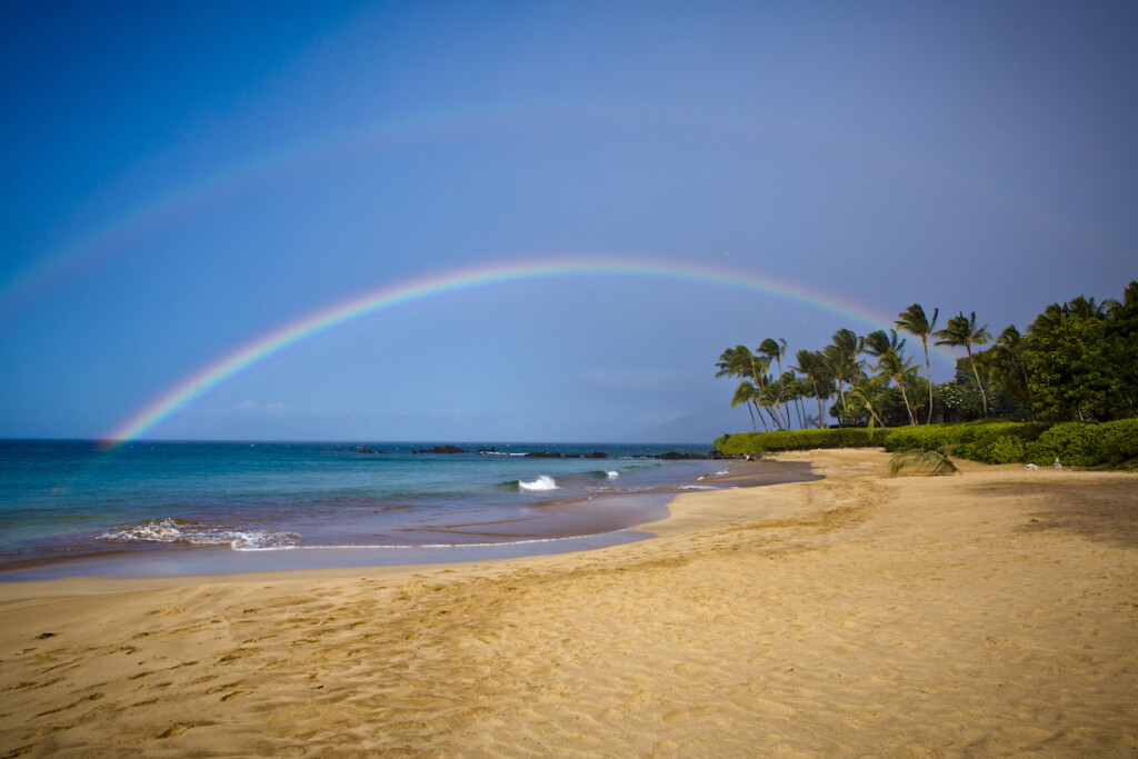 Empty Sandy Beach With Rainbow Arch.