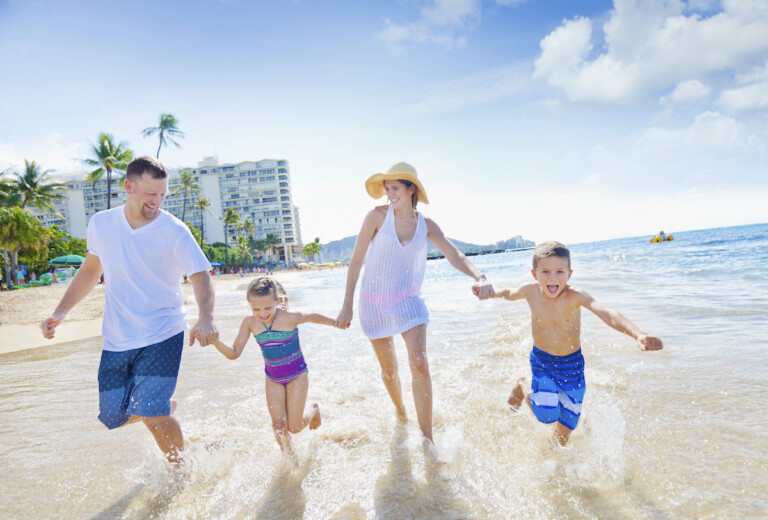 A Family Of Four Enjoying A Summer Vacation In Waikiki Beach