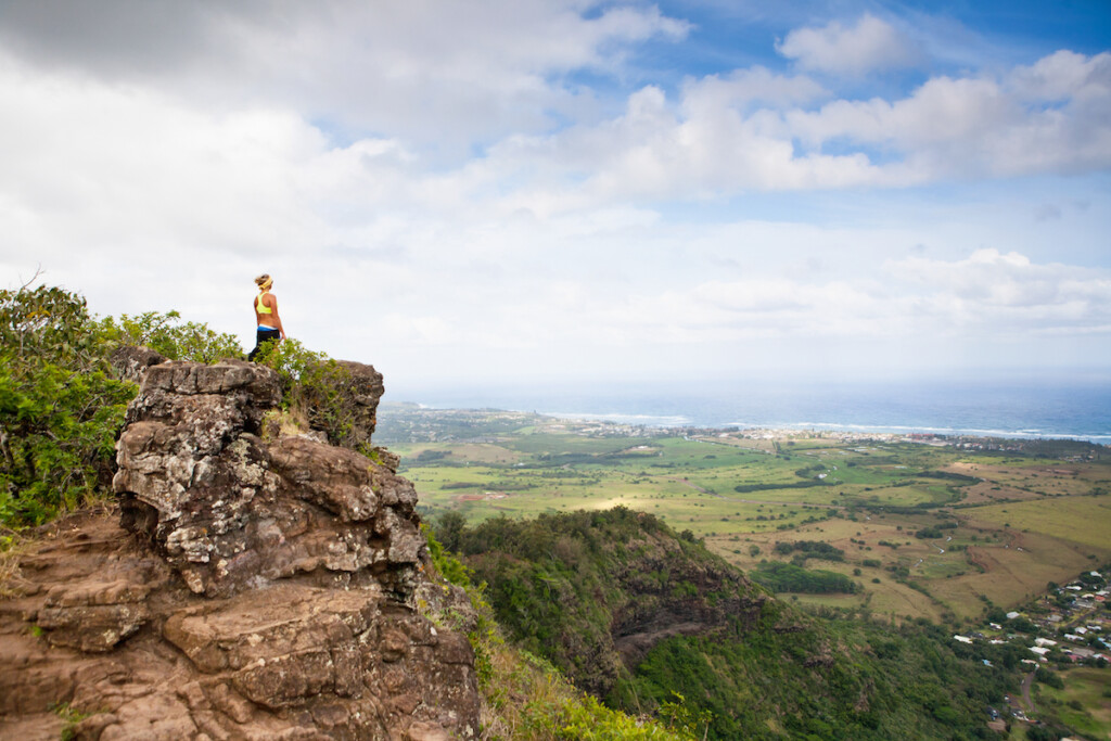 A Girl Reaches The Top Of The Mountain.